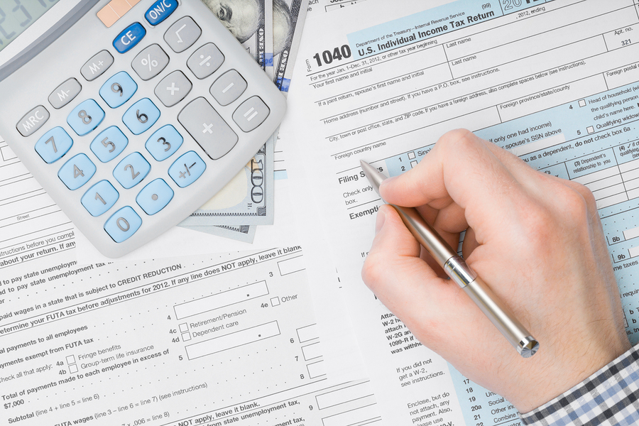 An employee is busy with Income tax return reports